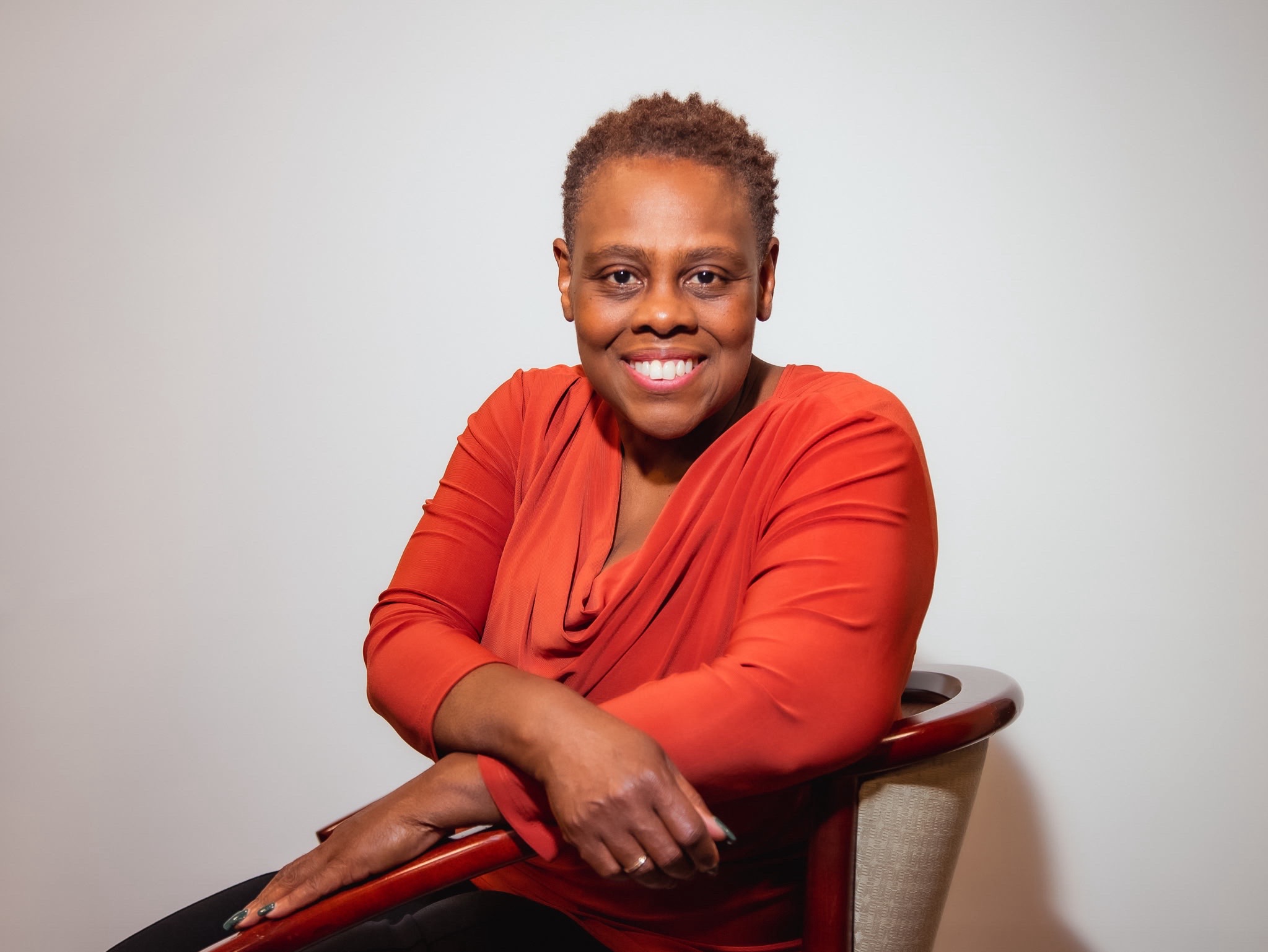 Dr. Gayl seated in orange top
